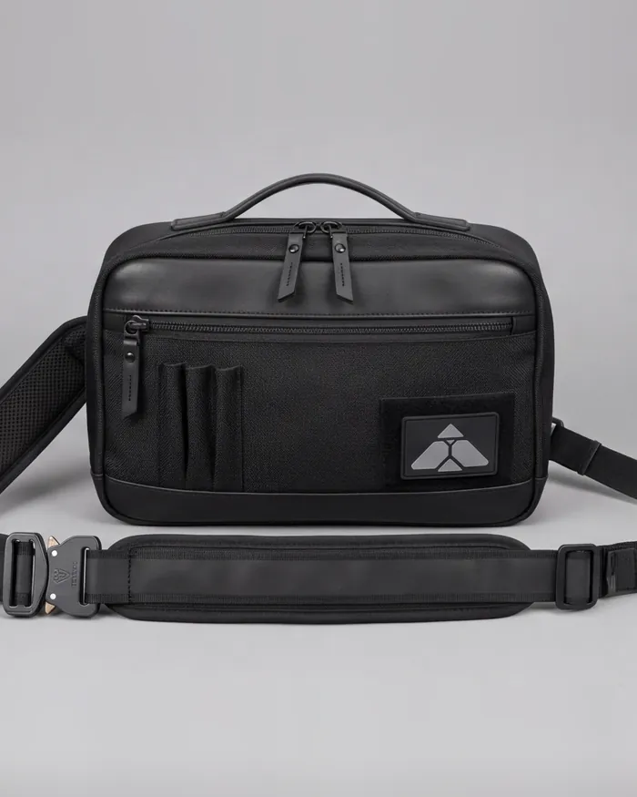 The sling from the front: a top handle, a front pocket, the mark on a patch