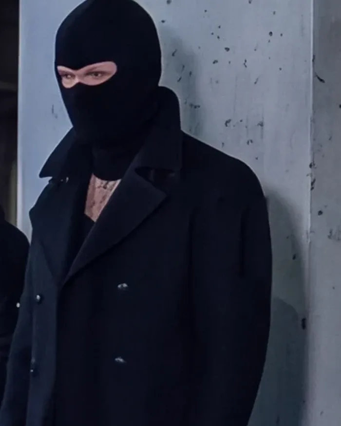 The Pea Coat worn buttoned, collar up, by a concrete pillar at night